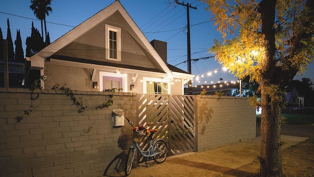 A house with a garage door, a bicycle, and a tree with autumn leaves. - Hollywood Family Nest in Burbank, Steps to Studios! (Burbank)