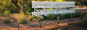 A stone sign with the text "Southside Lions Park" surrounded by greenery. - Beautifully Styled Home with Garage-Perfect Short or Long Stay! (San Antonio)