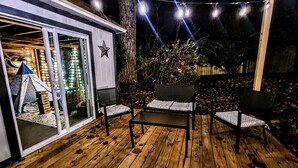 A wooden deck with a covered seating area, a small tent, and string lights. - Texas Sunshine Oasis WACO/Silos/Baylor: Pool, Piano, PingPong, Pets on 1/2 acre (Hewitt)
