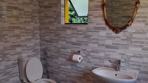 A bathroom with a toilet, sink, and decorative mirror. - Neo & ruks guest house (Cape Town)