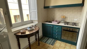 Basic Apartment | Private kitchen | Full-size fridge, stovetop, electric kettle, cookware/dishes/utensils