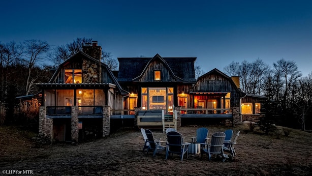 A large, rustic house with multiple rooms and a covered outdoor seating area. - The Chateau at Timberline (Davis)