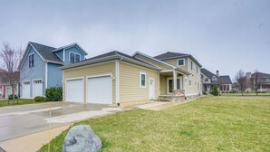 A residential neighborhood with houses featuring front garages and a well-maintained lawn.