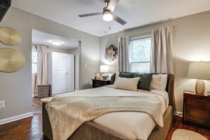 A bedroom with a bed, a nightstand, a lamp, a ceiling fan, and a window with curtains. - Updated Jamestown Home - 5 Mi to Hpu! (Jamestown)