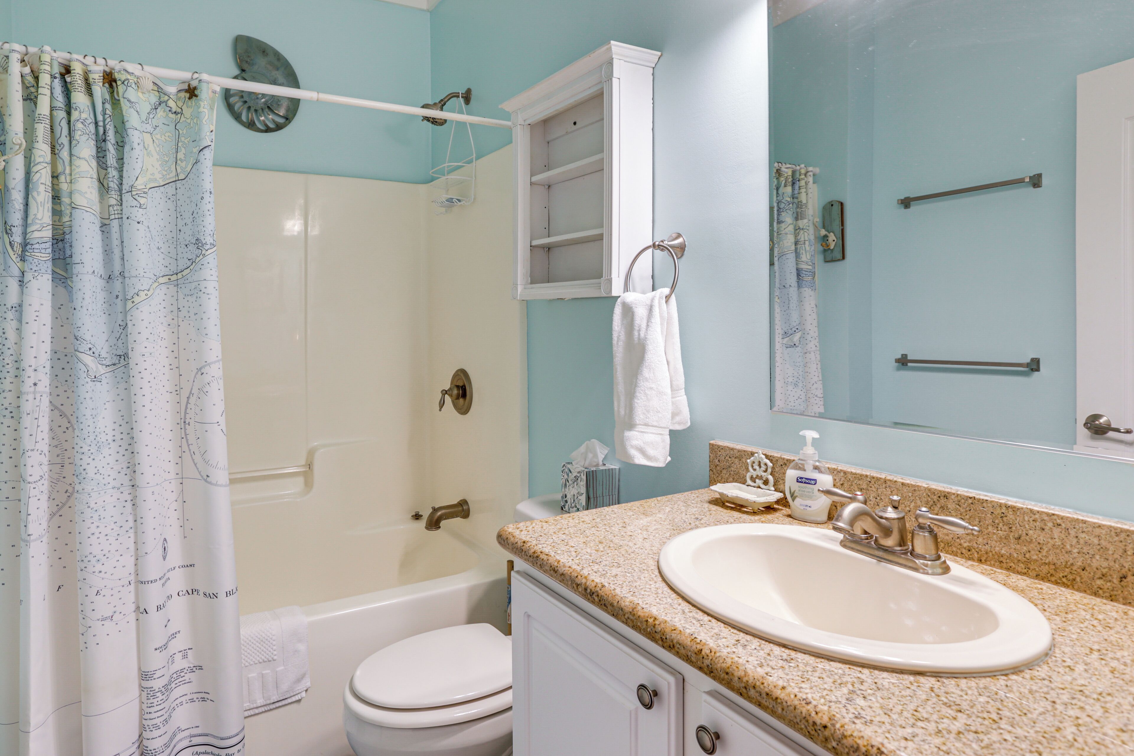 A bathroom with a sink, toilet, and shower.