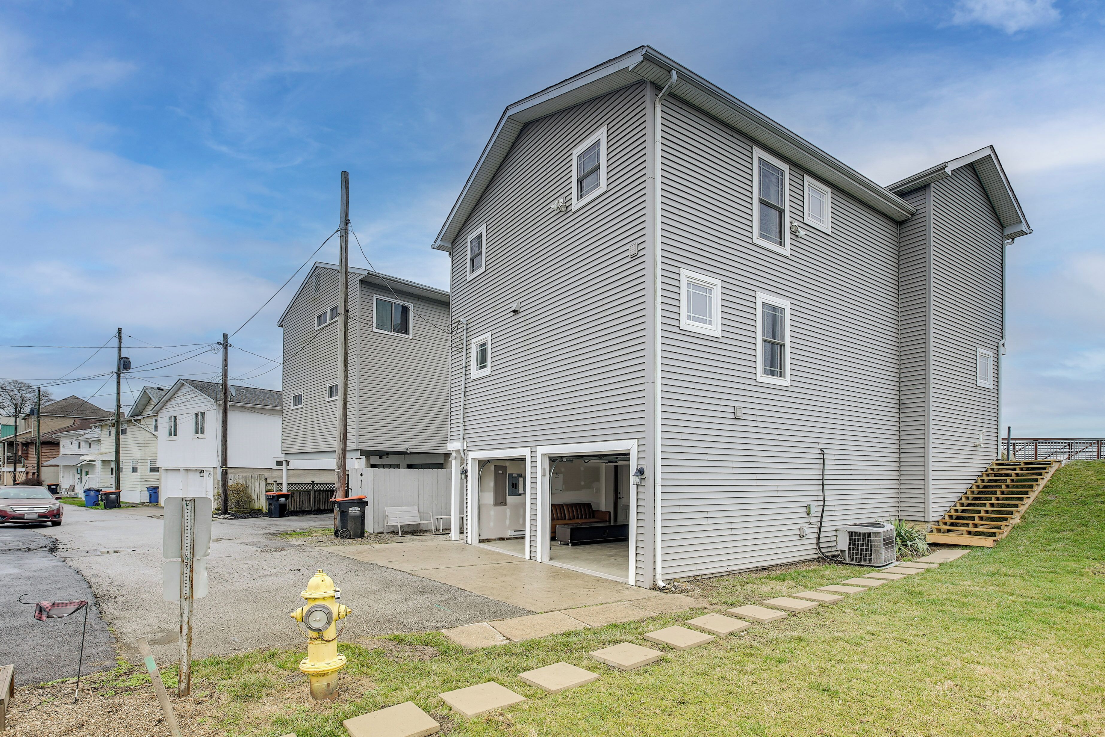 A two-story residential building with a garage and a covered outdoor area.