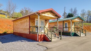 A wooden cabin with a porch and a staircase leading to a covered area. - Near Hiking & Biking: Newport Cabin in the Smokies (Newport)