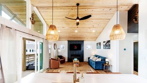 A modern kitchen with a central island, wooden ceiling, and pendant lights. - OBX Couples Getaway With Hot Tub-Short Walk to the Beach (Rodanthe)