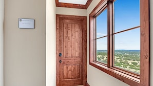 A wooden door with a nameplate reading "Lighthouse Hill Ranch The Louis XIV Suite."