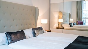 A hotel room with a large bed, a mirror, and a nightstand. - Vienna Residence, Pramergasse - Inner City #6325 (Vienna)