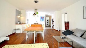 A modern living room with a wooden dining table, a glass coffee table, and a sofa. - Vienna Residence, Steckhovengasse - Hietzing #4888 (Vienna)