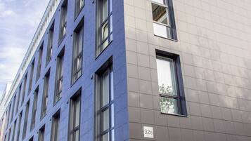 A modern building with a mix of window styles and a flat roof.