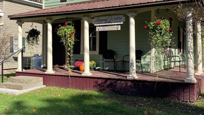 A two-story house with a porch, a sign reading "Leaping Waters," and a mailbox. - Leaping Waters - peaceful home located along the West Canada in Barneveld, NY.   (Barneveld)