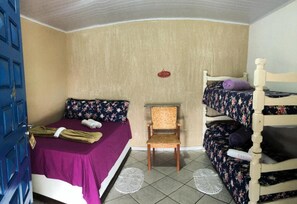 A small, compact room with a single bed, a chair, and a bunk bed. - Canto do Mar  (Angra dos Reis)