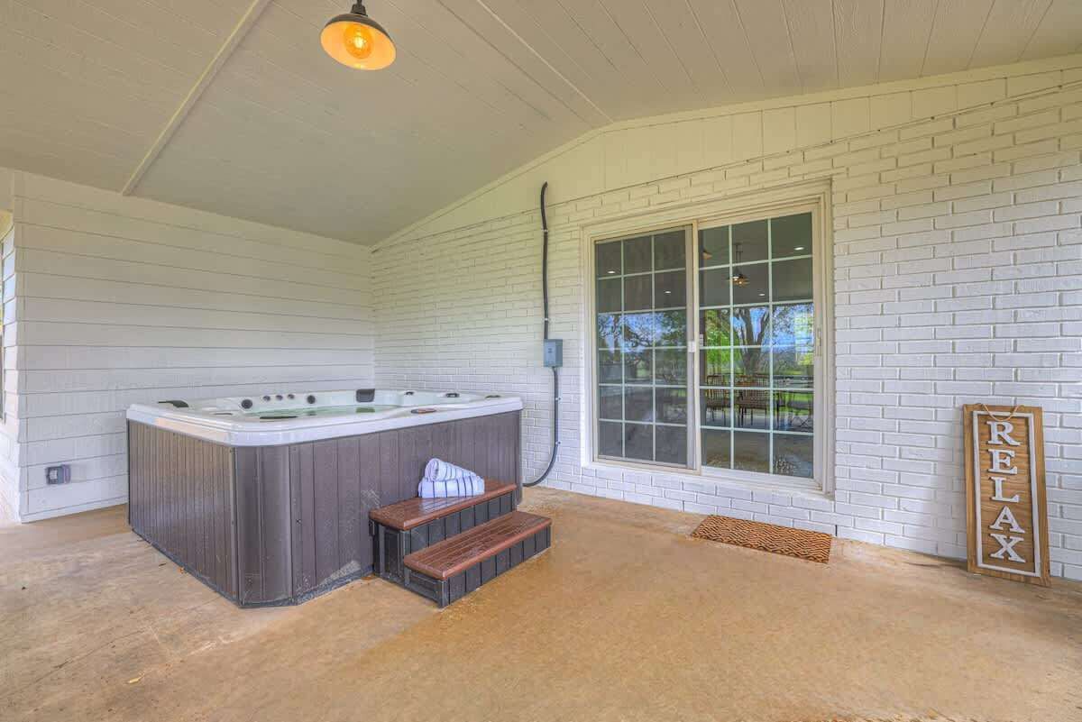 A spa area with a hot tub, wooden steps, and a 'RELAX' sign.