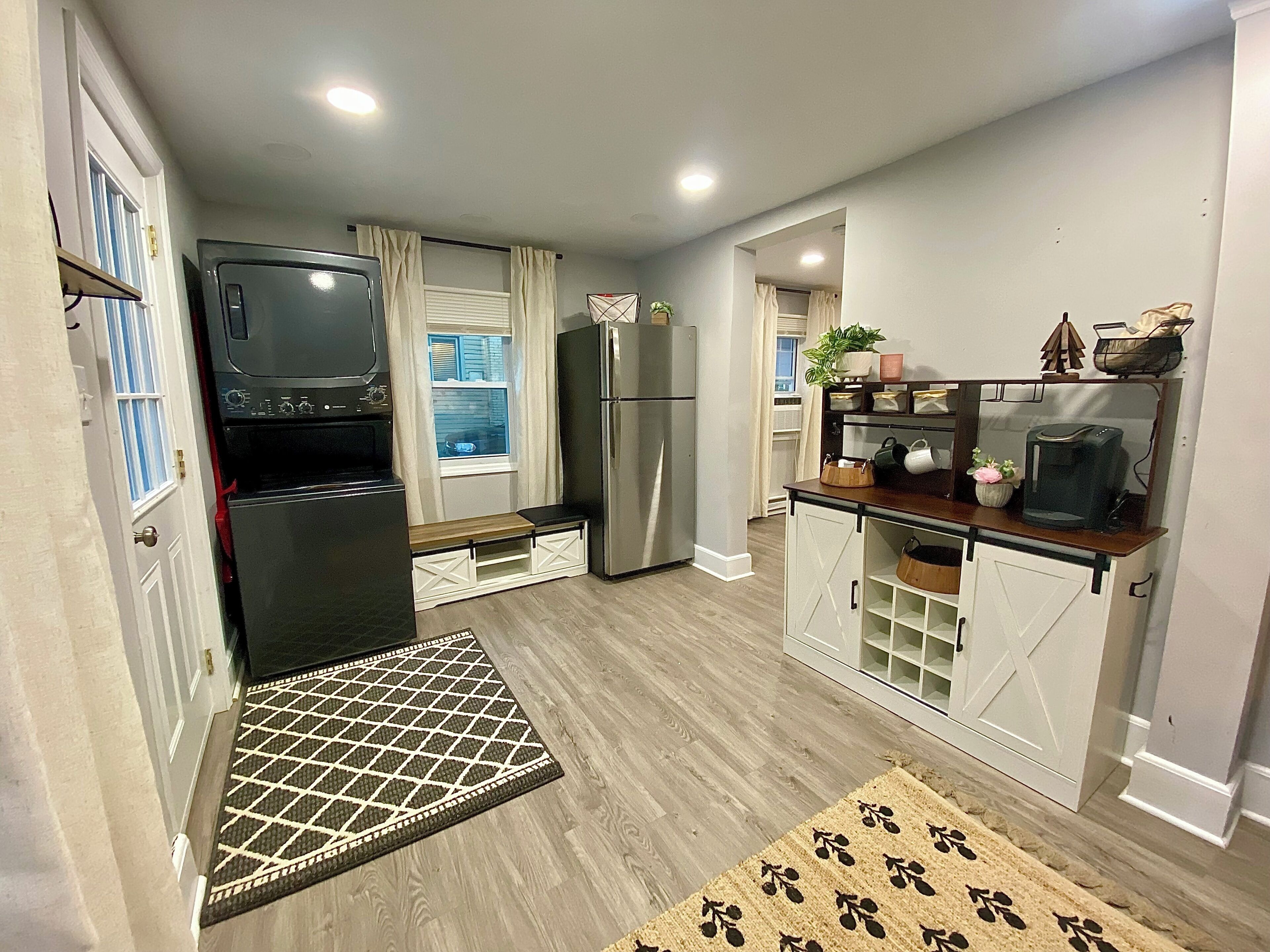 A compact kitchen with a refrigerator, stove, and microwave.