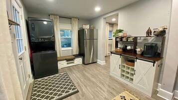 A compact kitchen with a refrigerator, stove, and microwave.