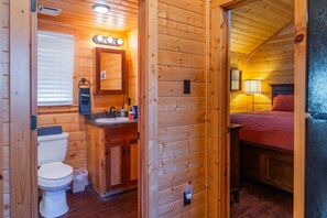 A wooden cabin interior with a bathroom and a bedroom. - Cabin 2 at Widows Peak • Terlingua, Big Bend (Terlingua)