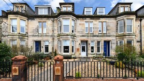 A historic stone building with multiple bay windows and a prominent entrance. - The Townhouse (Ayr)