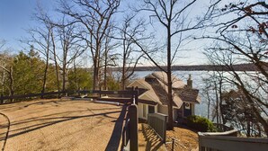A cabin with a view of a lake and a bridge in the background.