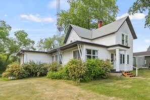 A two-story house with a gabled roof, a chimney, and a satellite dish. - Gather the Fam! Close to everything, Home Theater, 2 Kitchens, 2 Living Rooms! (Wisconsin Dells)