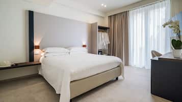 Comfortable bed, bedside tables, and a spacious wardrobe are conveniently located in this stylish room.