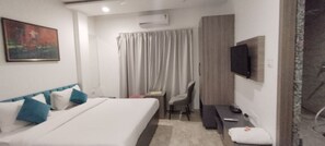 Relax in a stylish room with a comfortable bed, flat-screen TV, and desk area.