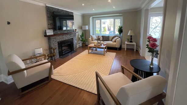 A living room with a fireplace, a sofa, a coffee table, and a TV. - Cozy House,  cottage style in midtown Toronto. Great for Family. Pet friendly  (Toronto)