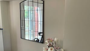 A room with a large window, a white vase with flowers, and wooden flooring. - Cozy House,  cottage style in midtown Toronto. Great for Family. Pet friendly  (Toronto)