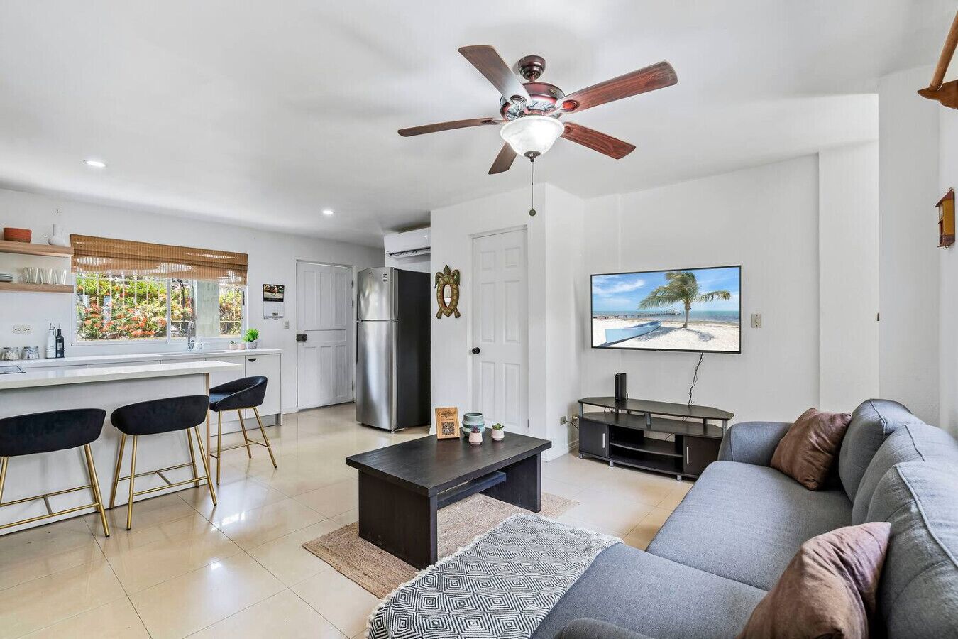 A modern living space with a kitchen, dining area, and a living room.