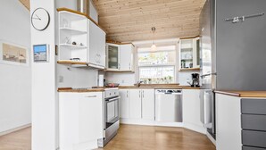 A modern kitchen with white cabinetry, a stainless steel refrigerator, and wooden countertops. - 3 bedroom amazing home in Vestervig (Vestervig)