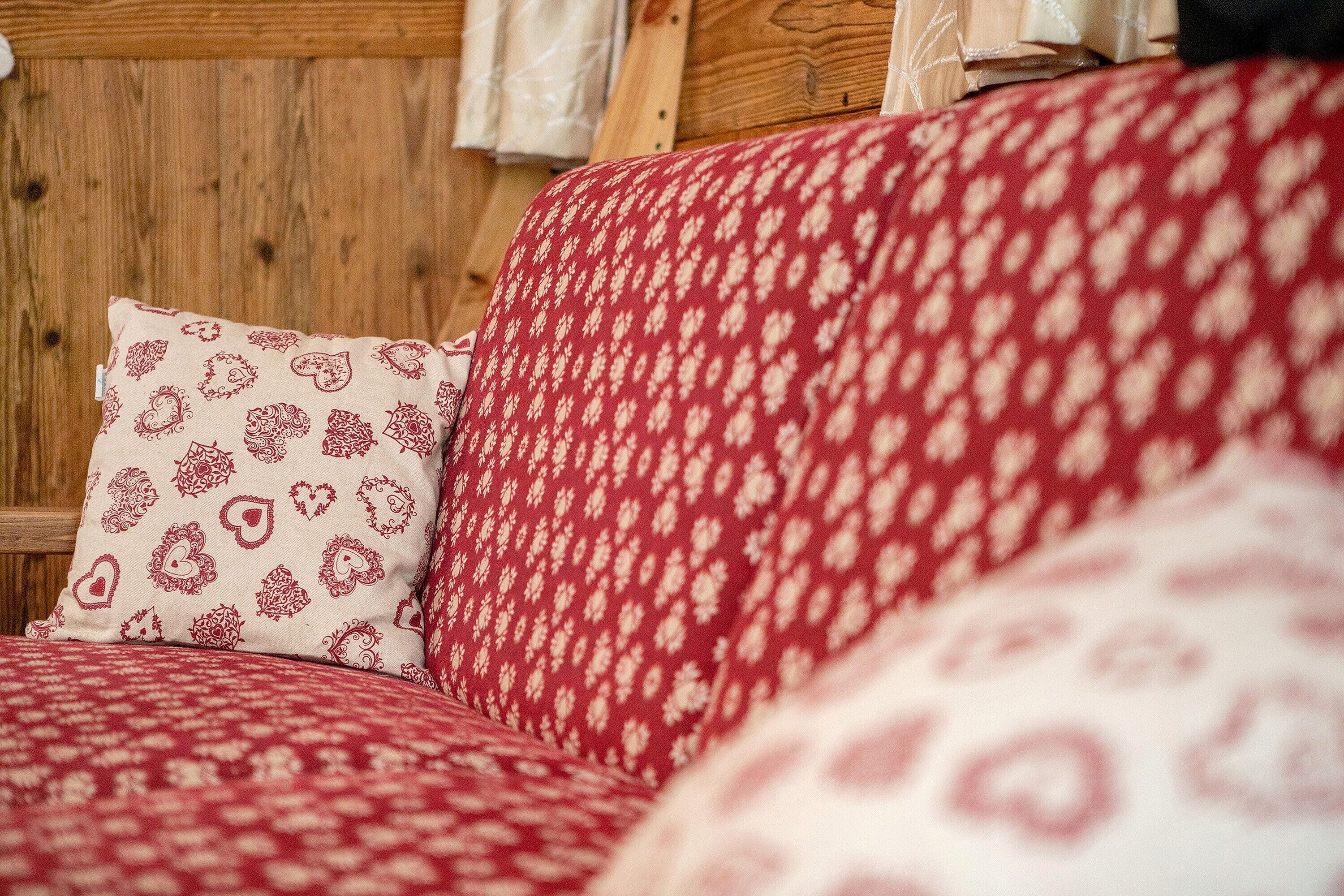 A bed with patterned bedding and a wooden headboard.