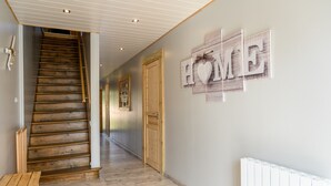 A wooden staircase leading to a room with a 'HOME' sign on the wall. - Holiday Home 'Gîte Les 3 Cerfs - 3 Stars' with Mountain View, Private Terrace & Wi-Fi (Plainfaing)