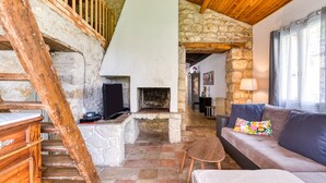 A rustic interior with a stone fireplace, wooden staircase, and a cozy seating area. - Cottage 'Maison De Campagne' with Private Terrace, Private Garden and Wi-Fi (GIGNAC)
