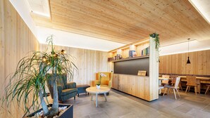 A modern interior with wooden walls, a round table, and a seating area.