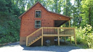 A wooden cabin with a wooden deck and a small window. - Great small cabin with hot tub (Bryson City)