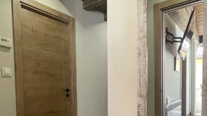 A hallway with a wooden door and a white wall. - YourHouse A Casa Da Corona, beautiful country house (Ourense)