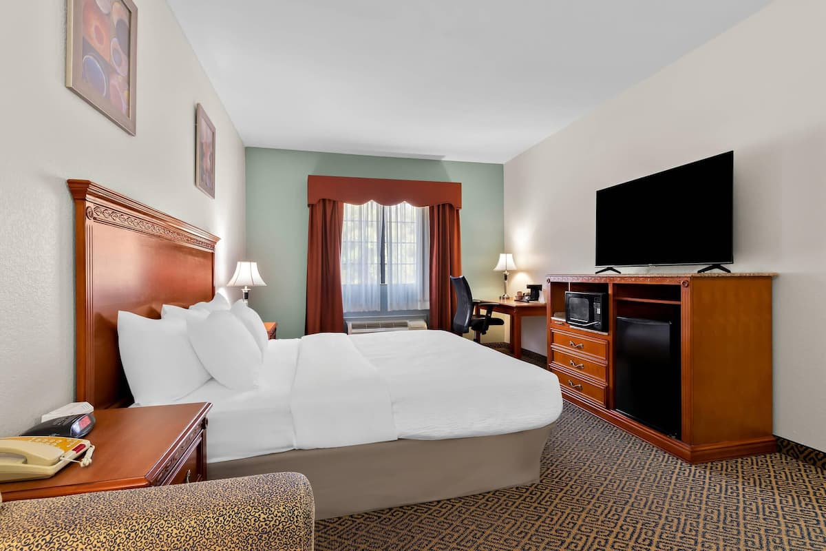 Premium bedding, desk, laptop workspace, iron/ironing board