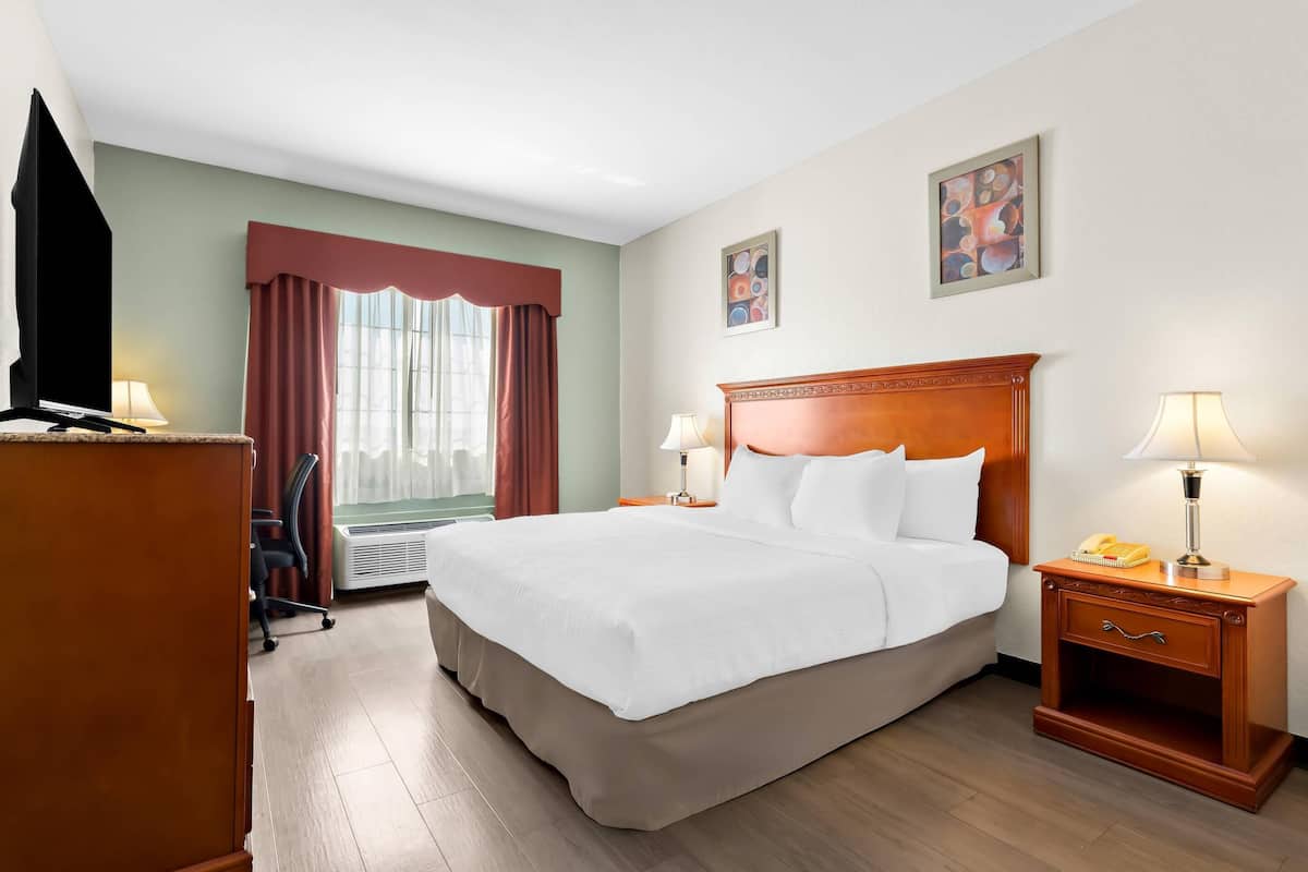 Premium bedding, desk, laptop workspace, iron/ironing board