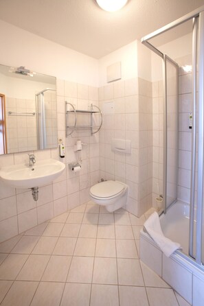 A modern bathroom with a sink, toilet, and glass shower enclosure. - Hotel & Restaurant Zum Kap Arkona (Putgarten)