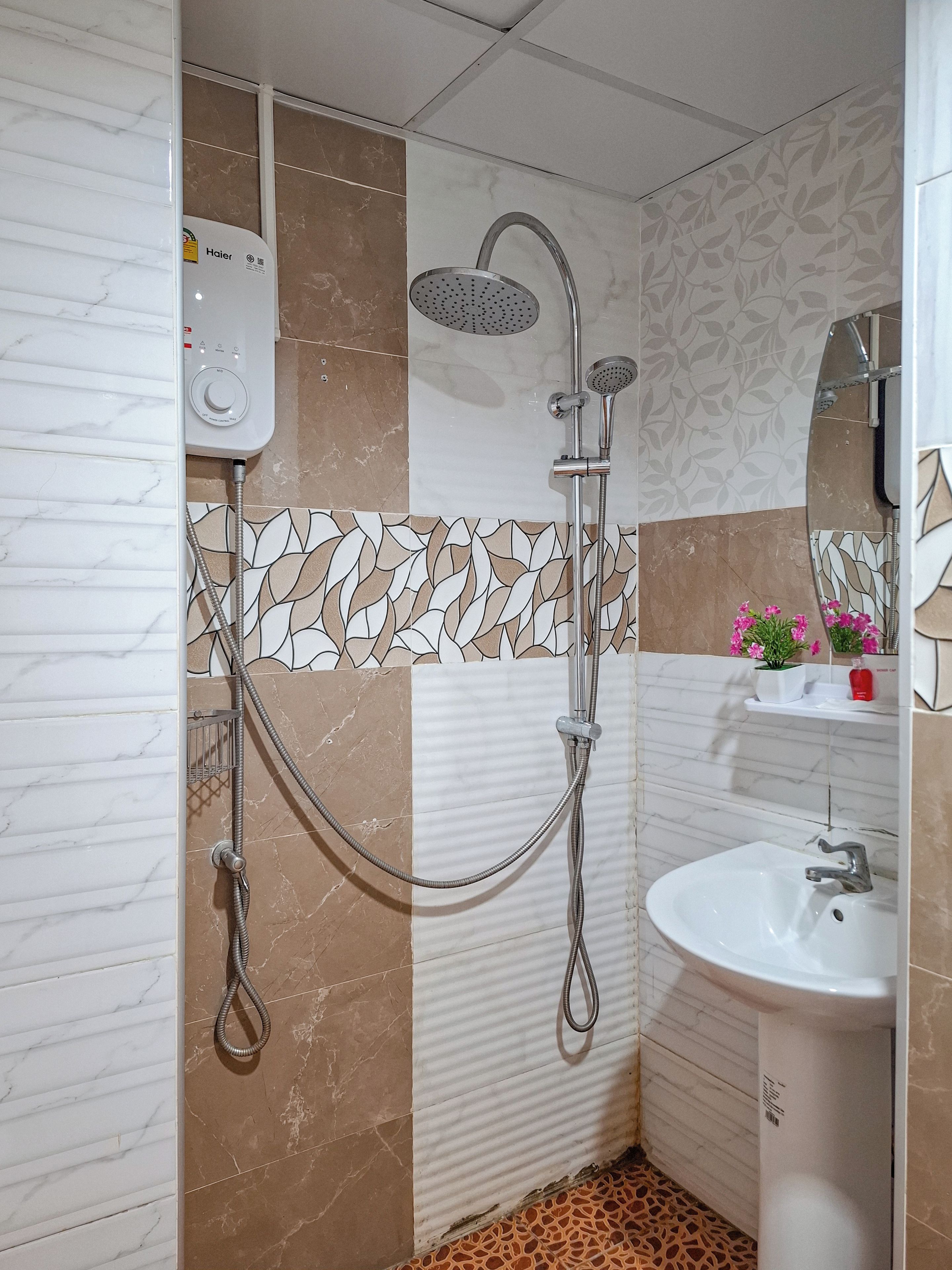 A bathroom with a shower, a sink, and a toilet.