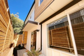 Enjoy an outdoor space with a small garden and large windows with horizontal slats.