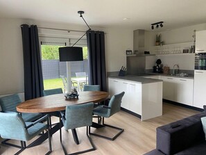 Cozy living space with a central dining area, kitchen, and comfortable seating.