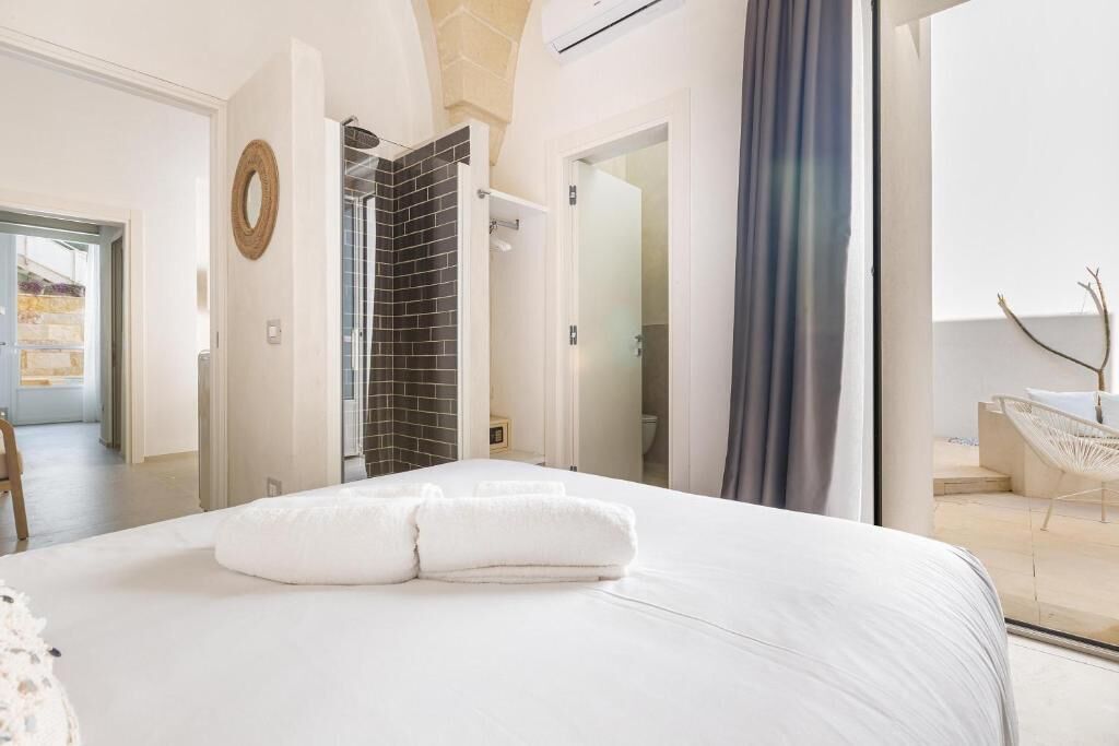 Departamento superior, 2 habitaciones, vista parcial al mar | 2 habitaciones, edredón y caja de seguridad en la habitación 