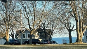 A residential area with a house, parked cars, and leafless trees. - Charming Falmouth Heights Steps to Beach (Falmouth)