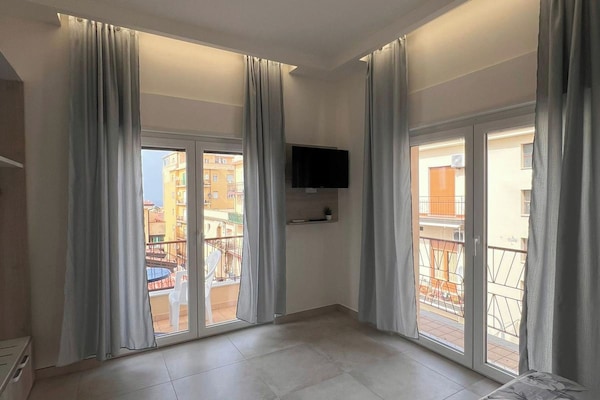 Deluxe Room, Sea View | Minibar, in-room safe, desk, laptop workspace