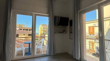 Deluxe Room, Sea View | Minibar, in-room safe, desk, laptop workspace