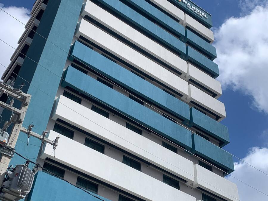 Un hotel de varios pisos con diseño moderno, que presenta un llamativo logo 'W' en la parte superior.