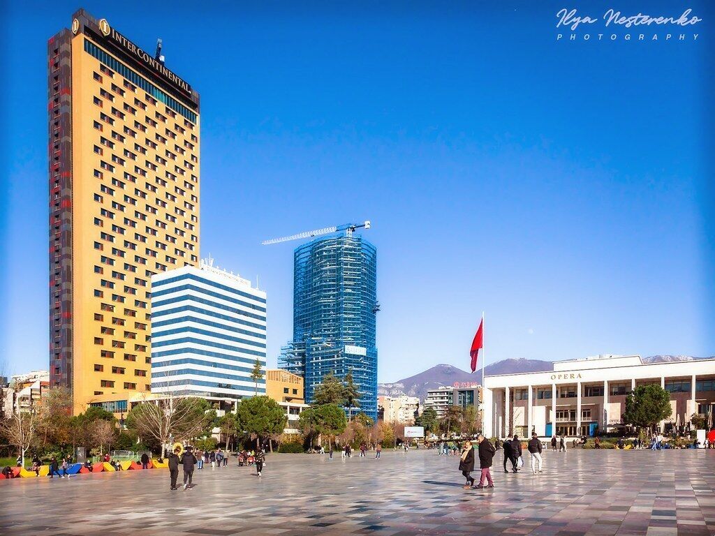 A city square with a large building labeled "INTERCONTINENTAL" and another building with a crane.