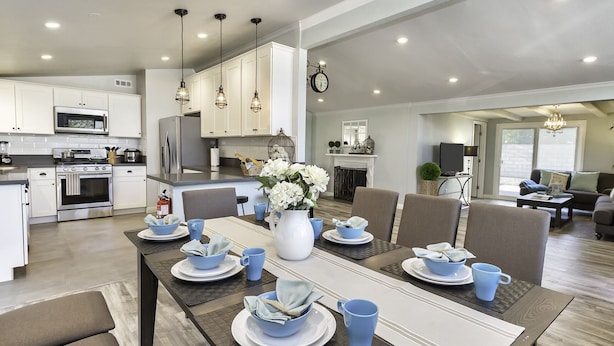 A modern kitchen with white cabinets, stainless steel appliances, and pendant lighting. - Walk across the street to Disneyland parking. Fireworks show from front porch! (Anaheim)